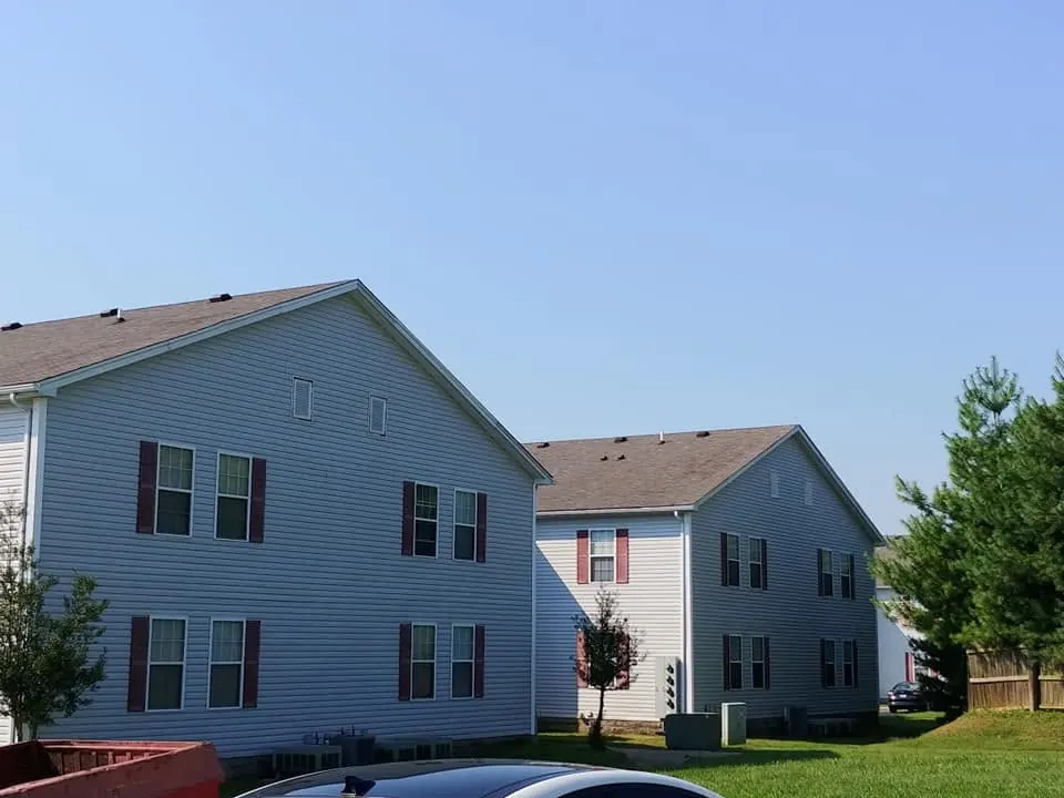 The same apartment buildings with clean, light siding after washing