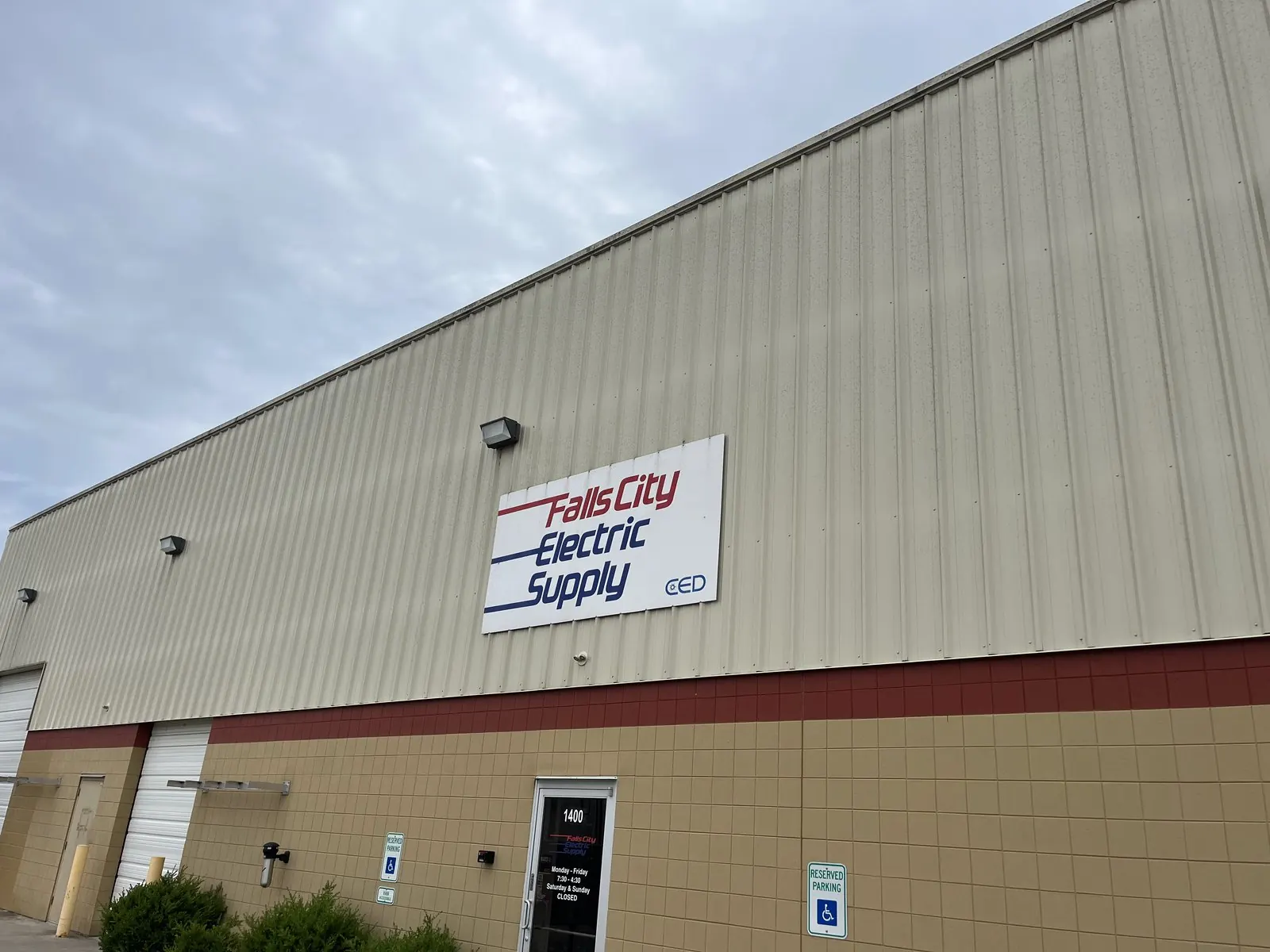 Metal warehouse building with a supplier sign