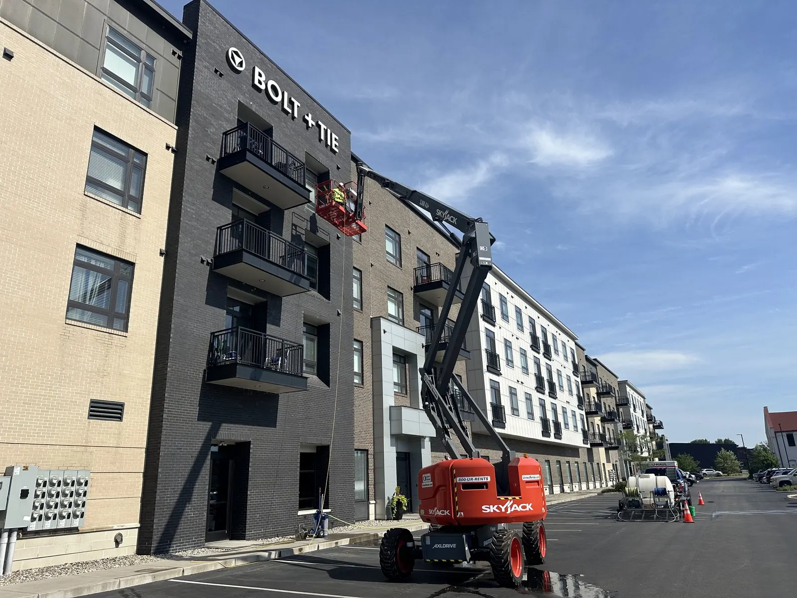 Boom lift at the balconies of a new apartment building
