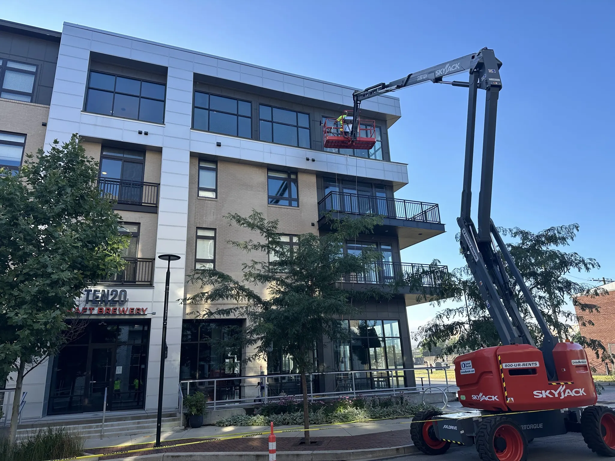 Boom lift at the windows of a mixed-use building
