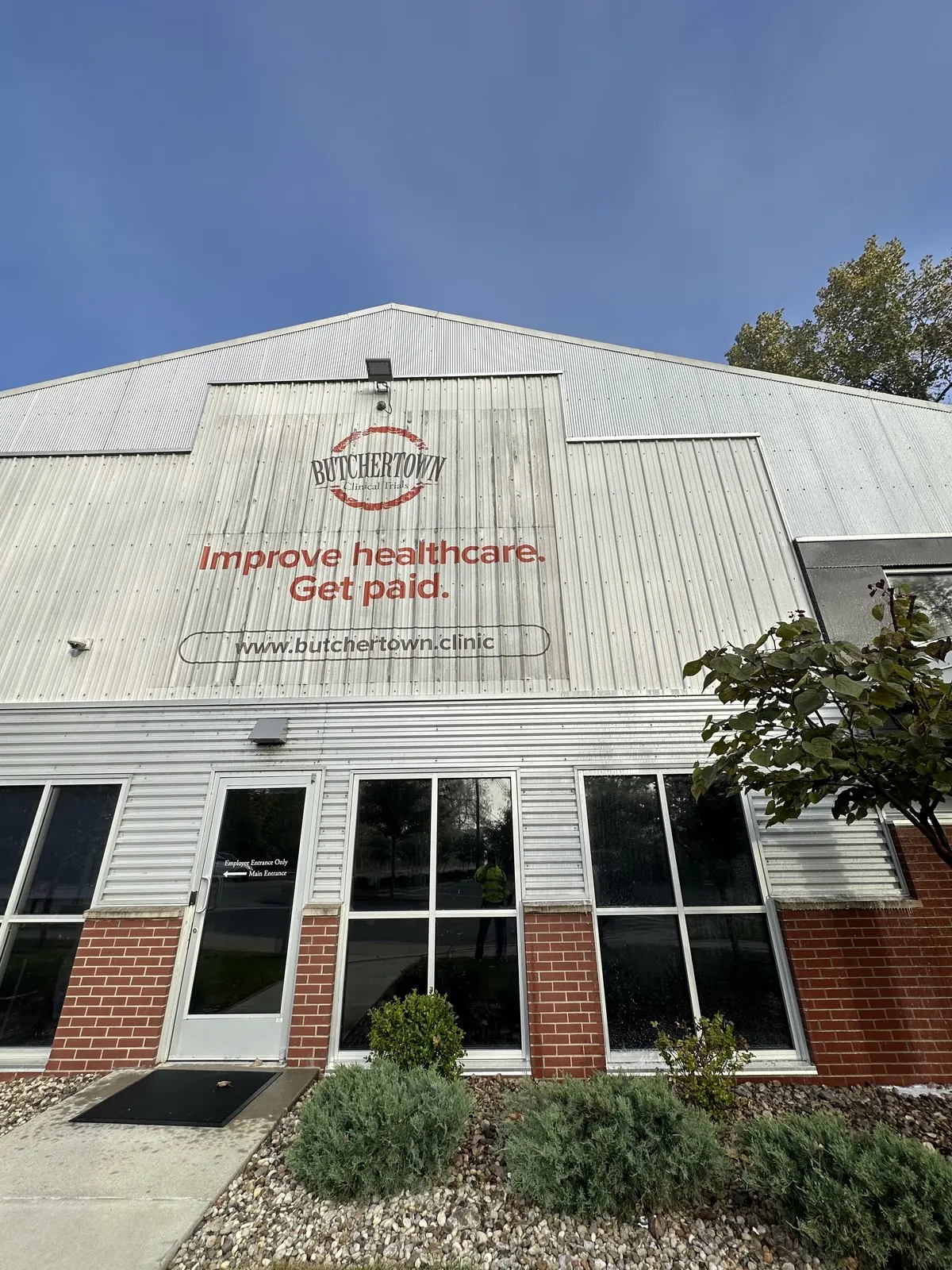 Clinic building with a large painted sign above the entrance