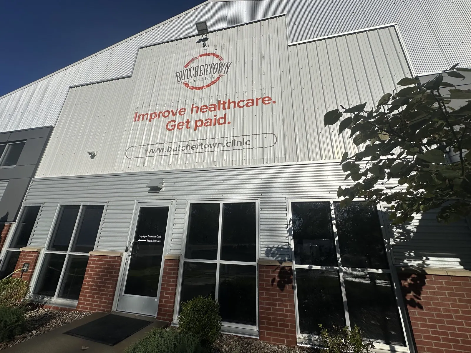 Clinic entrance with large windows below a painted sign