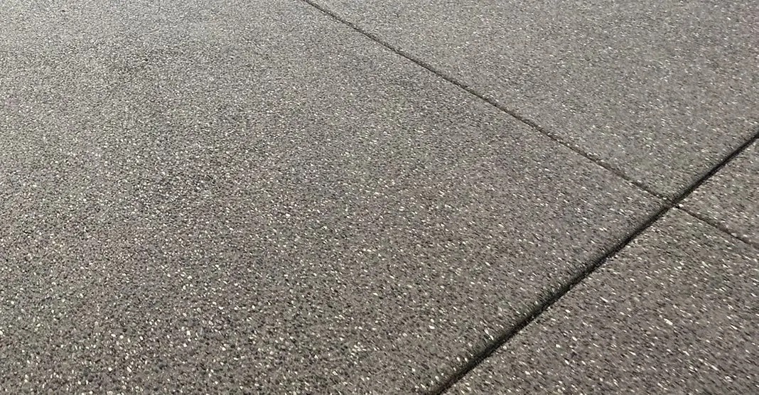 Close view of the stone texture of an exposed-aggregate concrete driveway