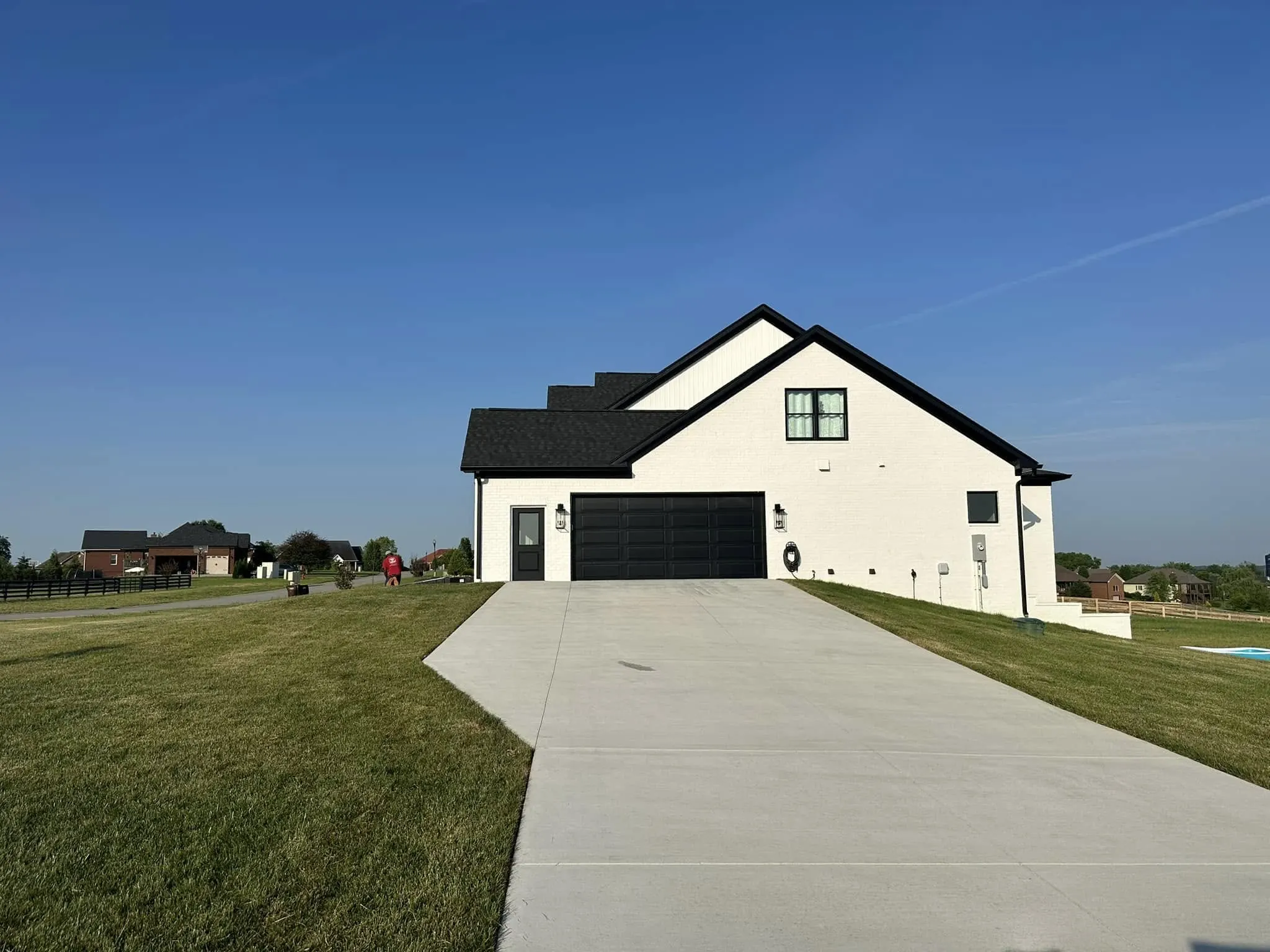 Clean concrete driveway in front of a house after pressure washing