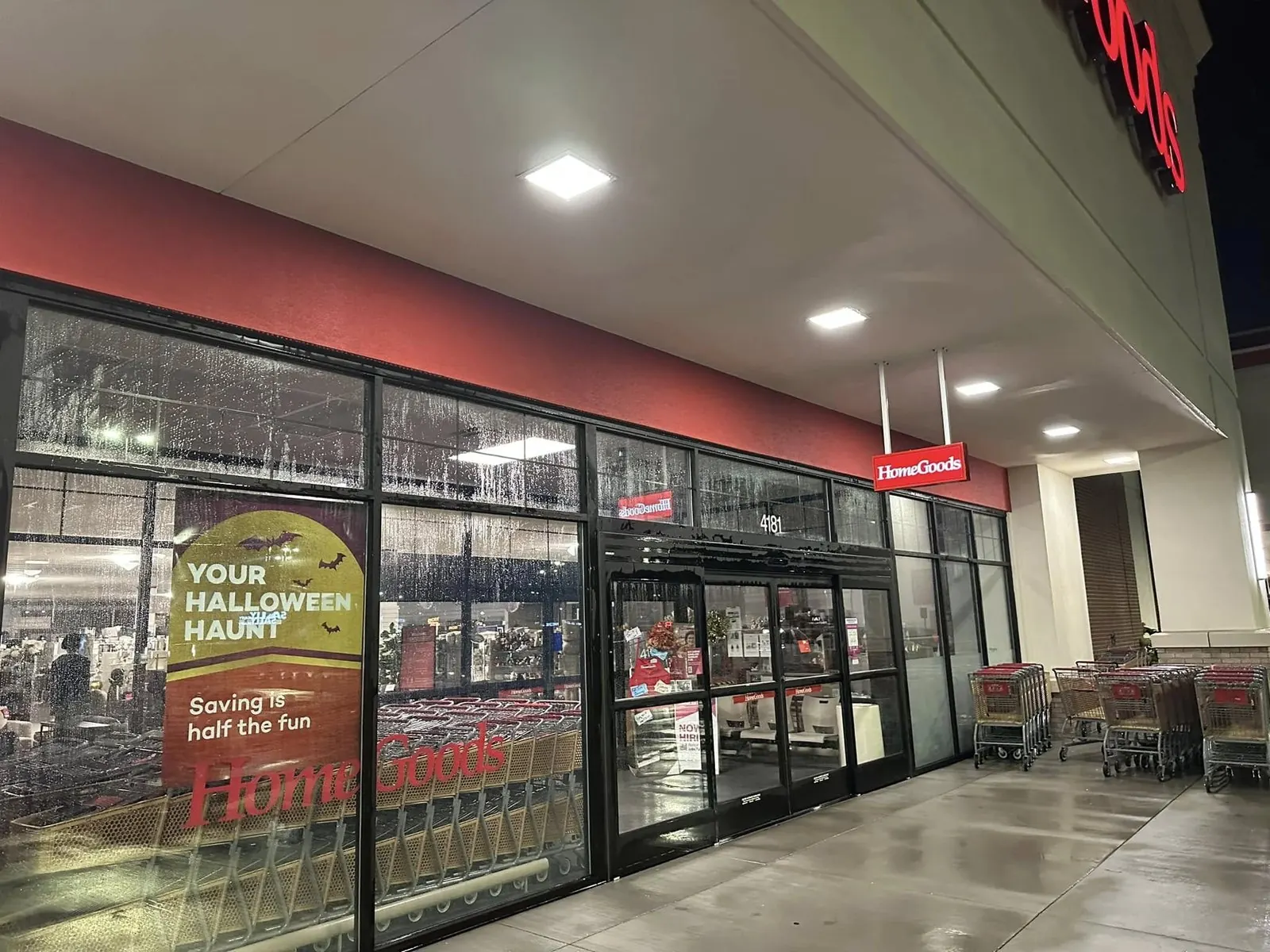 Clean storefront windows and sidewalk of a retail store at night