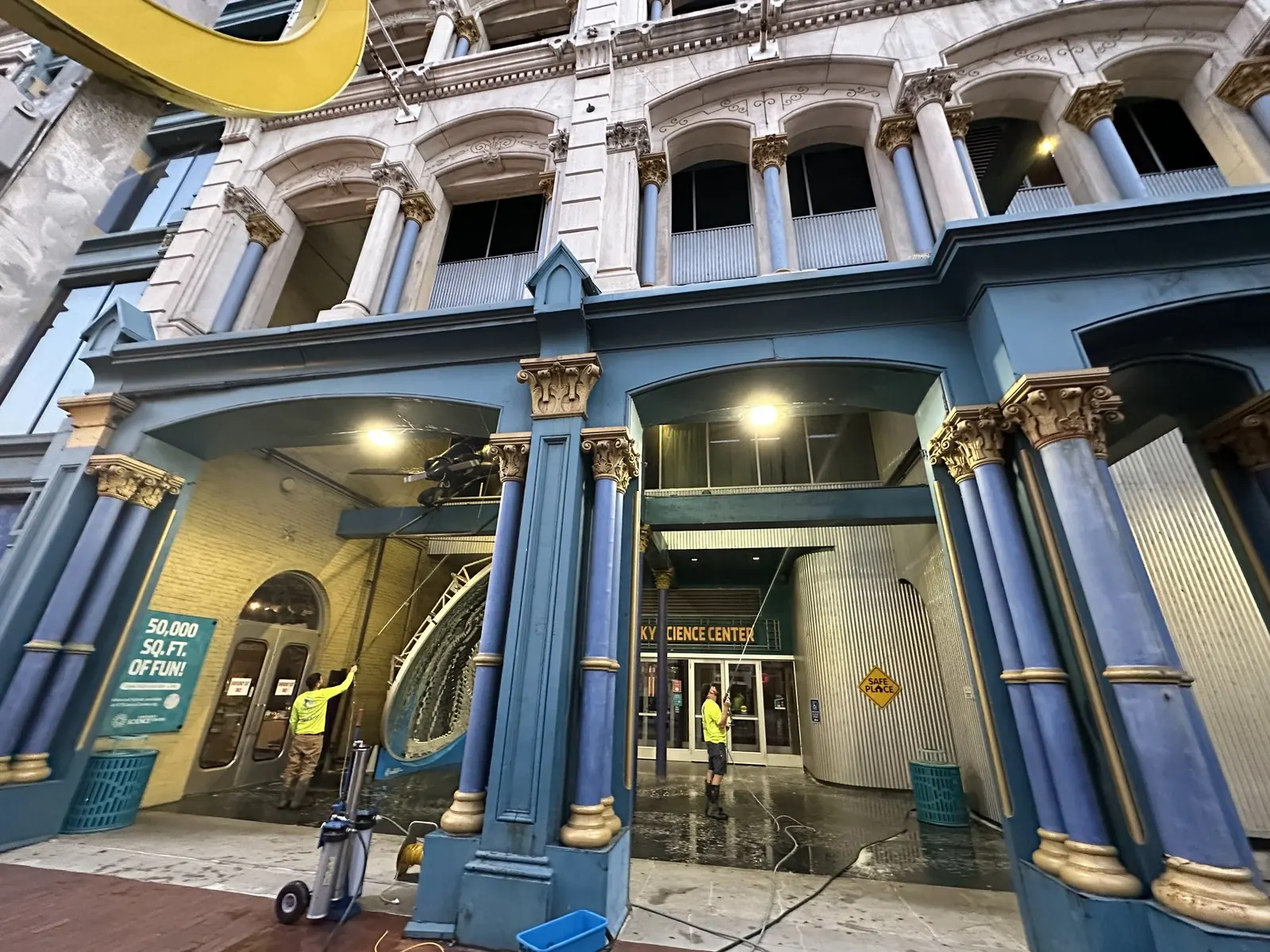 Washing the ornate entrance colonnade of a historic building