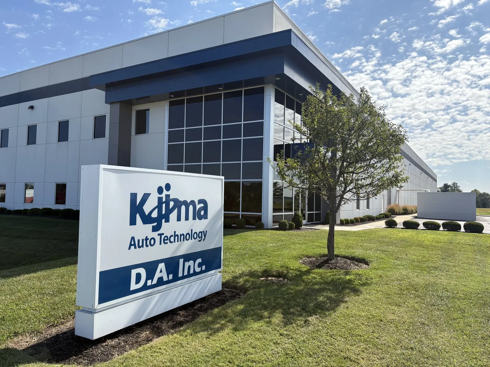 Modern industrial office building behind a monument sign