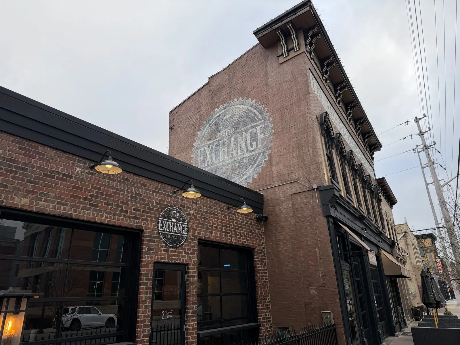 Brick event venue exterior with a large painted logo