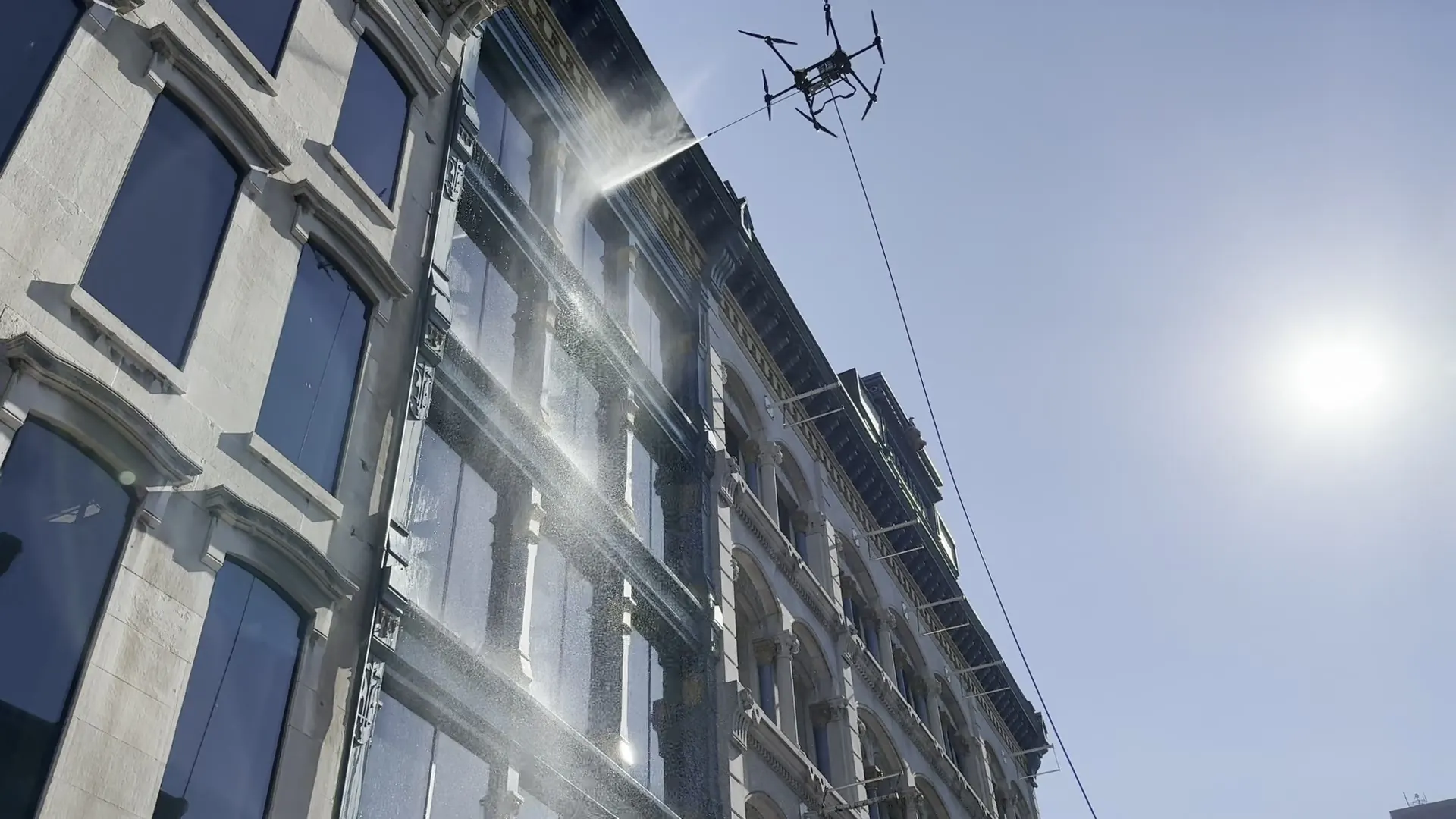 Drone spraying the facade of a historic building