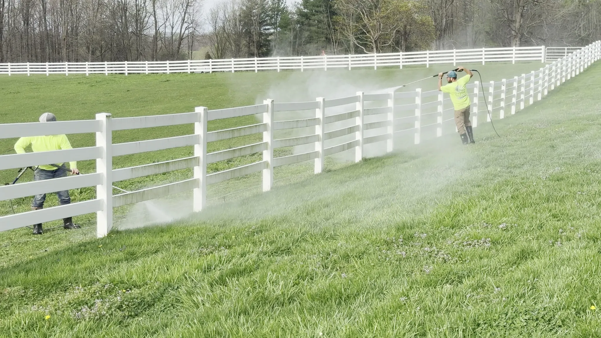 Washing a long white wooden fence